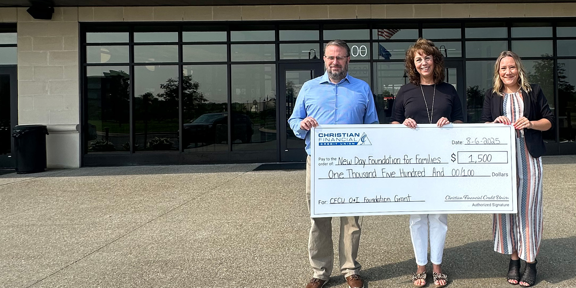 Check presentation in front of Christian Financial headquarters building
