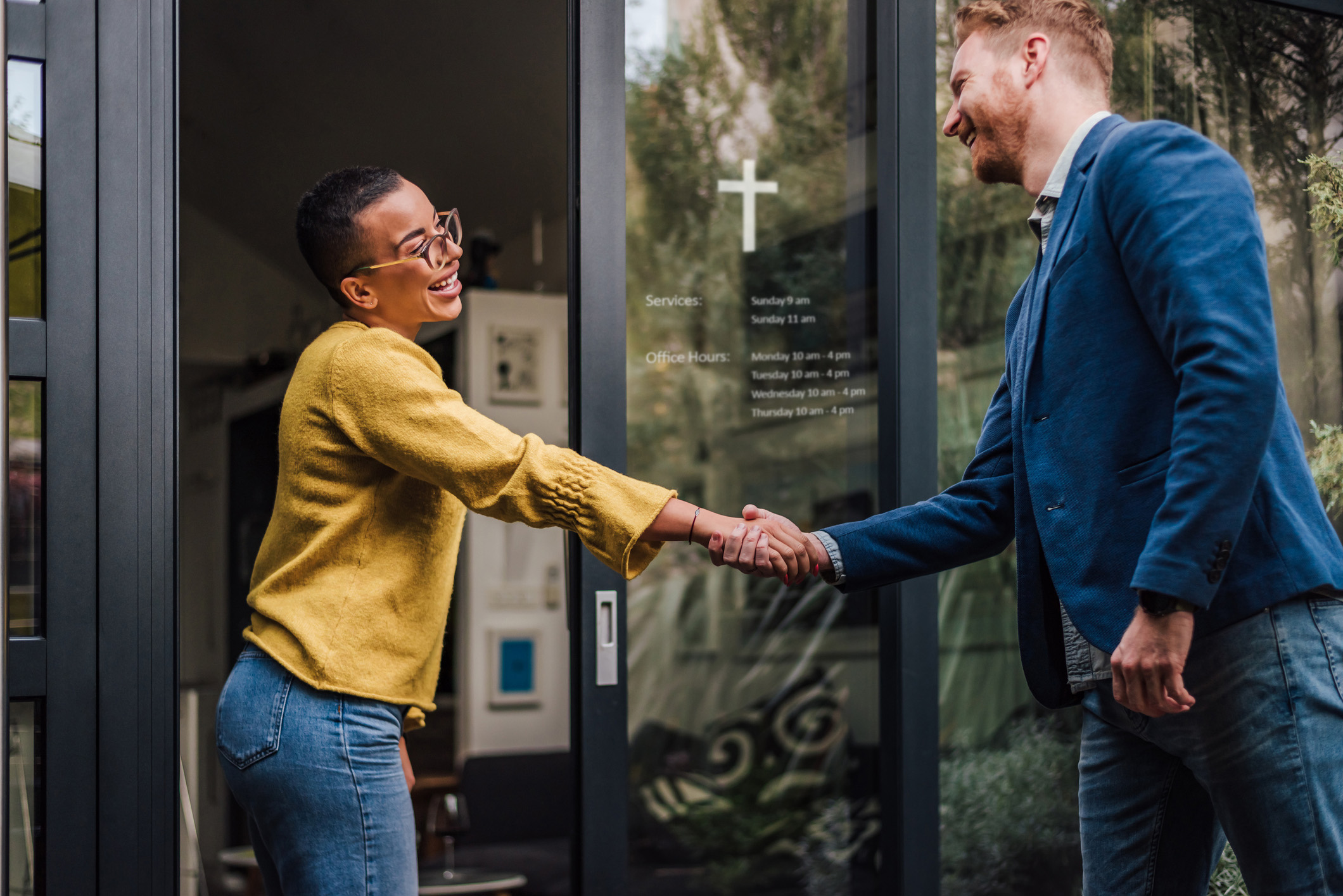 Meeting handshake outside a church door.