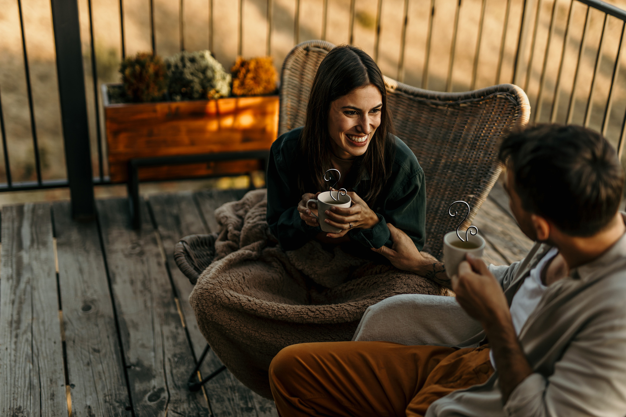 Couple drinking hot beverage outside with illustrated steam.